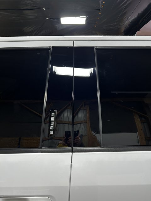The same pillar trim after paint correction and ceramic coating, swirl free with a mirror shine