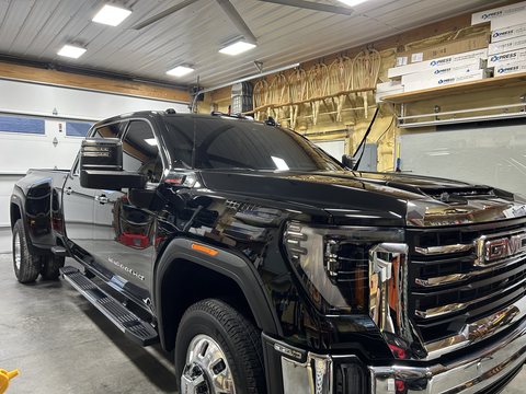Black GMC Sierra HD with ceramic coated paint inside the shop