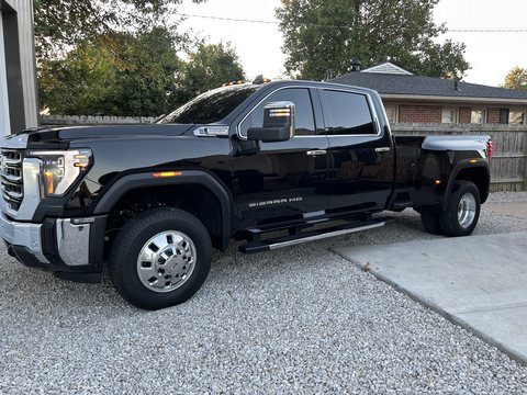 Black GMC Sierra HD dually with ceramic coated paint parked on a gravel drive