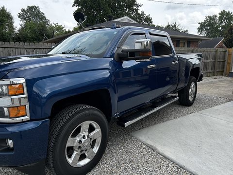Blue Chevy Silverado HD with ceramic coated paint on a gravel drive